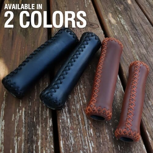 Leather bicycle handlebar grips in black and brown on wooden surface.